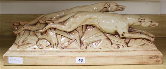 A ceramic Art Deco model of dogs, signed G.H. Gremion